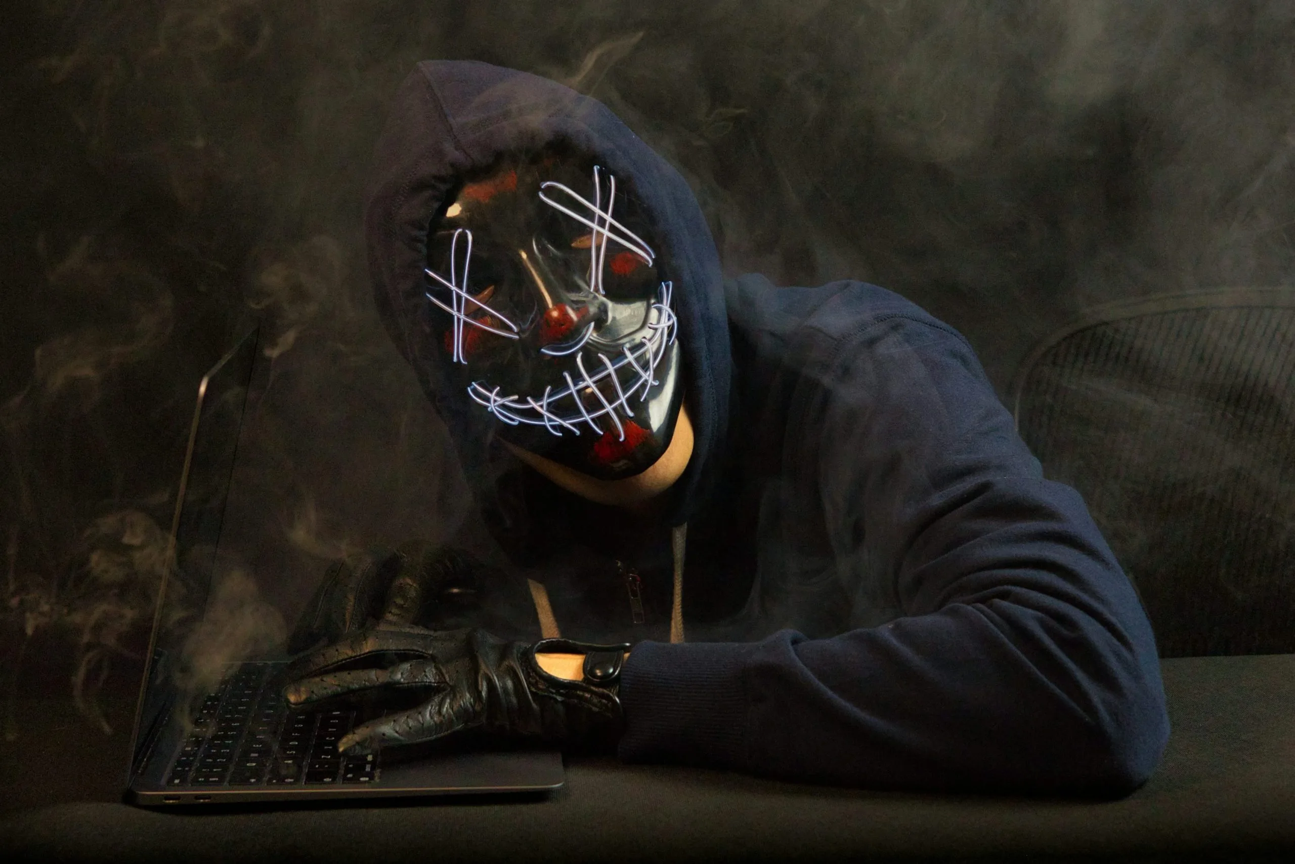 Hacker working on computer with cyber security background